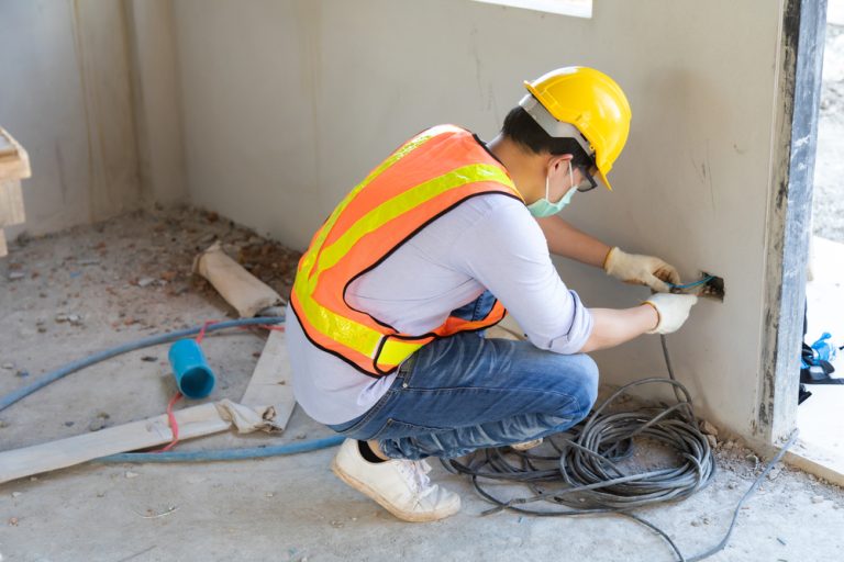 Worker repairing an area of a home during a renovation project