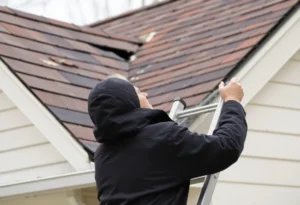 Homeowner inspecting roof for damage