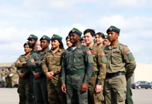 Diverse military personnel standing together in uniform.