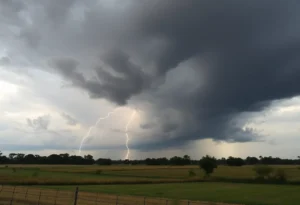 Dark storm clouds with lightning, indicating a severe thunderstorm