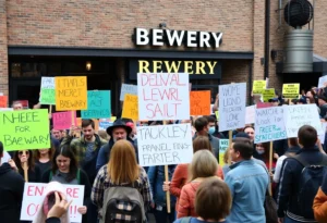 Protesters outside a town hall event for Nancy Mace holding signs
