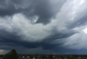 Dark storm clouds over a neighborhood indicating severe weather.