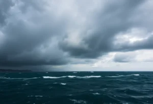 A hurricane developing over the ocean with dark clouds and waves