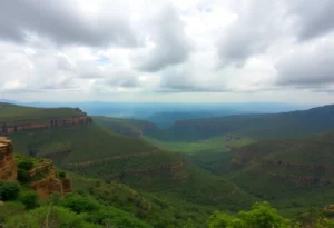 A panoramic view of the Aravalli hills showing elevated terrains and lush surroundings.
