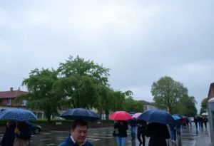 People with umbrellas walking in a rainy Rock Hill