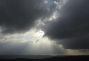 A cloudy sky above Rock Hill with hints of sunlight.